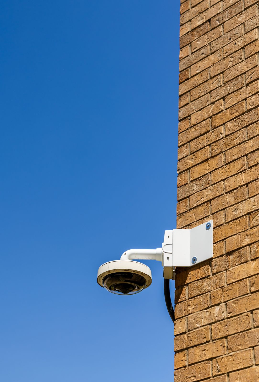 Security camera mounted on exterior wall